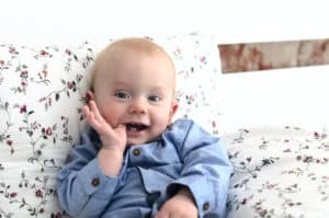 baby with finger in his mouth showing the potential for baby teeth and orthodontics