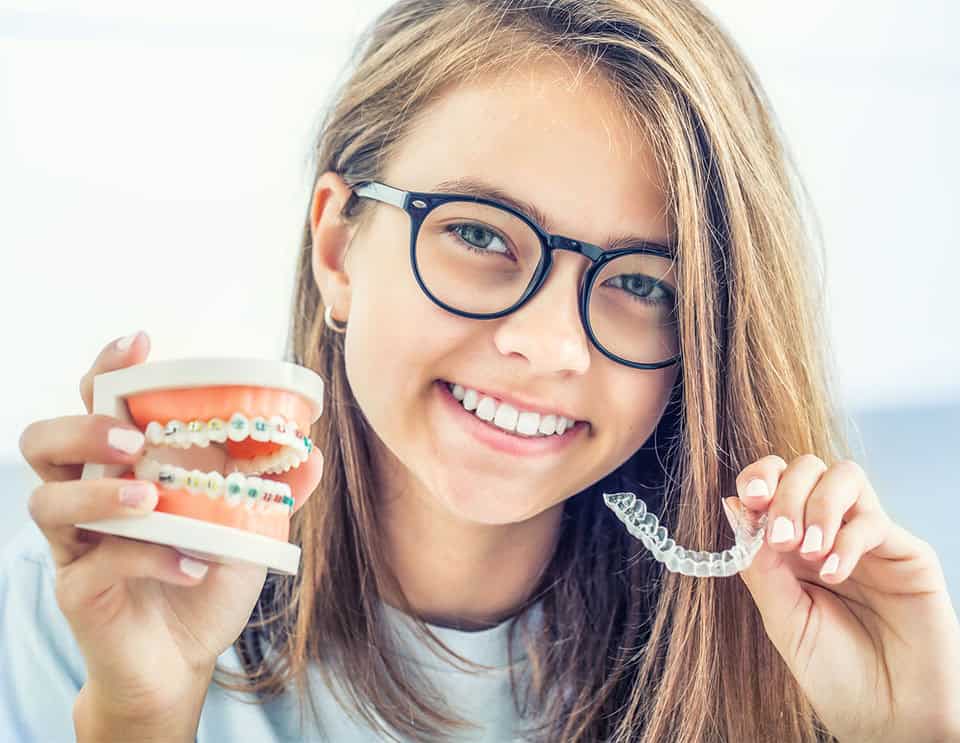 woman showing braces and invisalign aligners