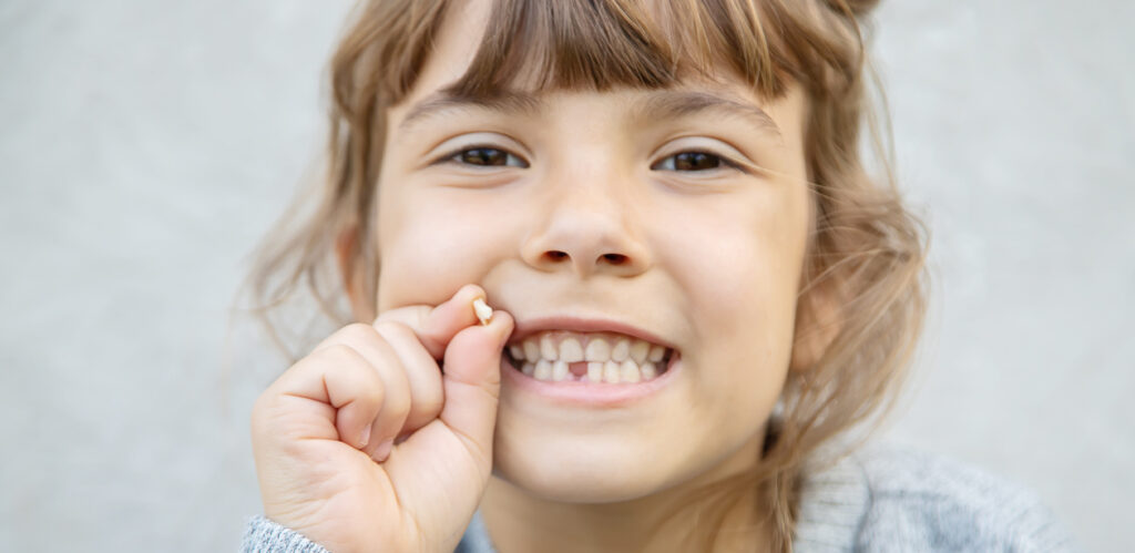 little girl with a missing tooth